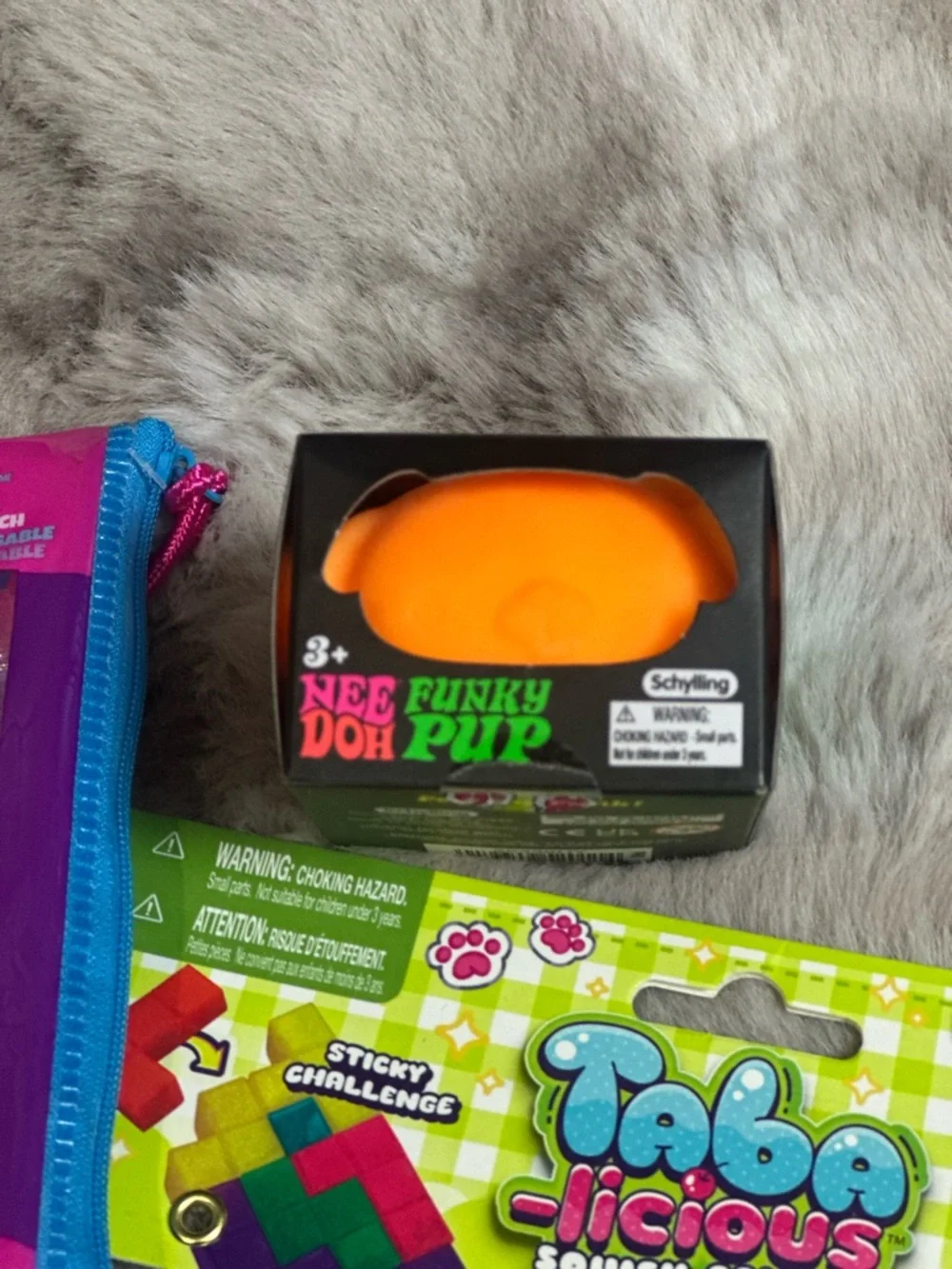 A Bundle of Squeezable’s with one orange NEE DOH FUNKY PUP. New